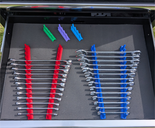 Modular spanner organisers installed in a toolbox drawer holding combination and ratchet spanners in an organised layout.