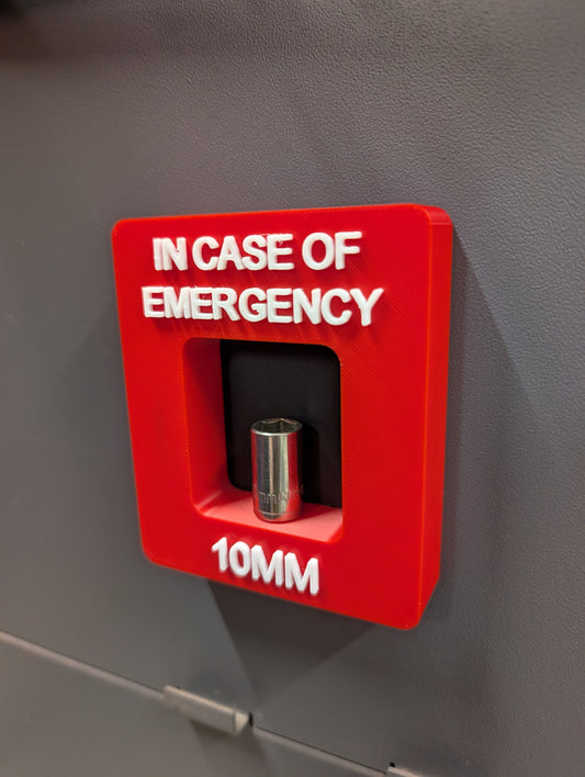Red emergency tool box with a 10mm socket on a gray background
